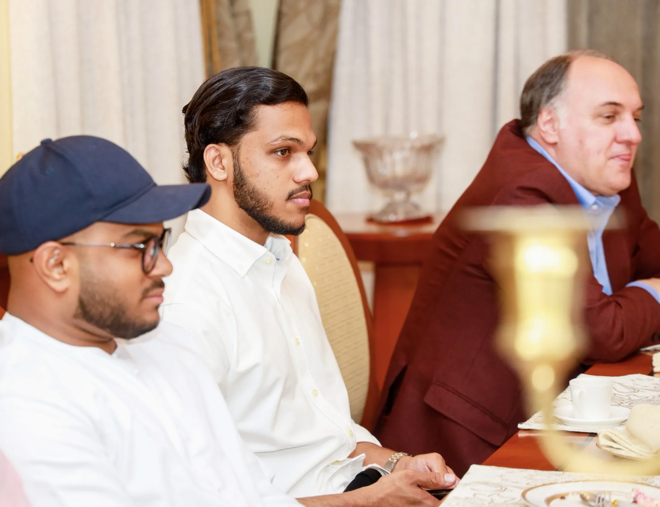 Muhammed Shafad in conversation around a dinner table
