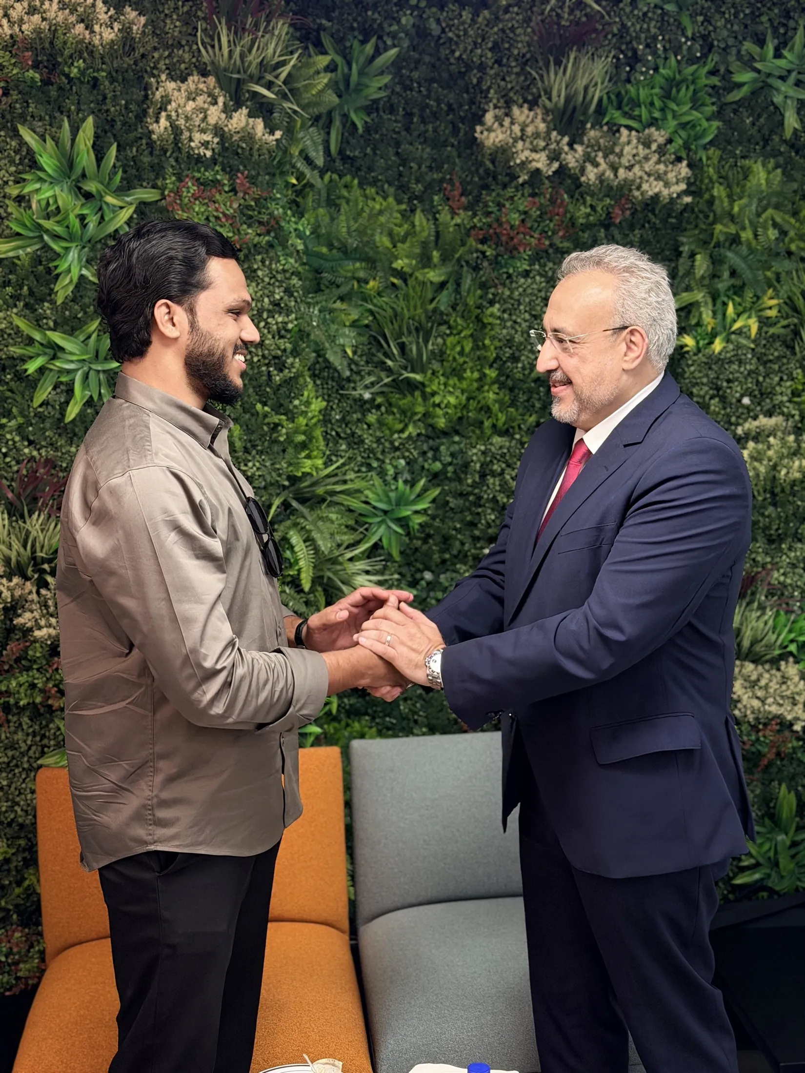 Muhammed Shafad shaking hands with a founder after a strategy meeting