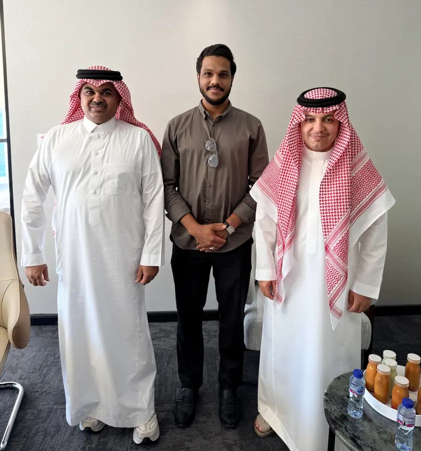 Standing together with two Gulf businessmen