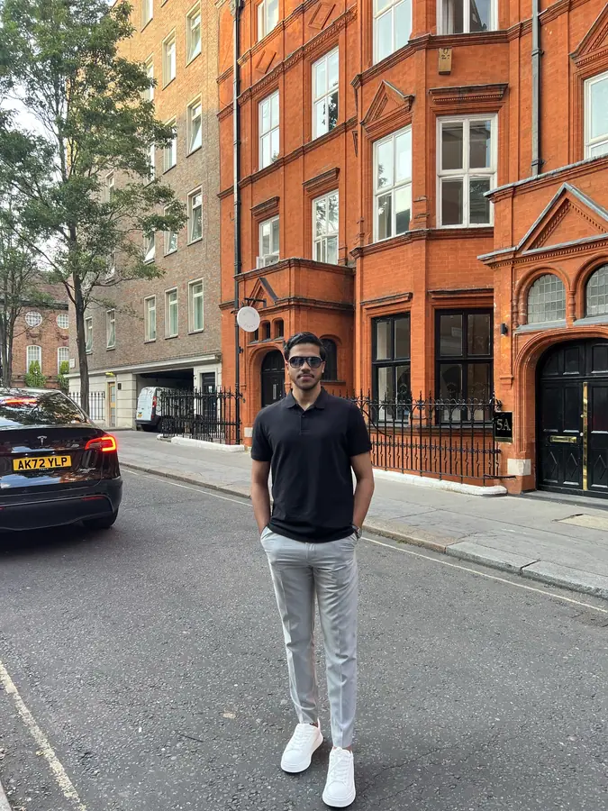 Muhammed Shafad on a London street lined with red-brick buildings