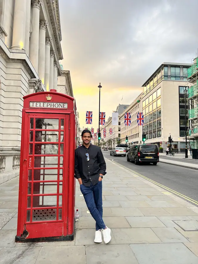 Muhammed Shafad beside a red telephone box in London