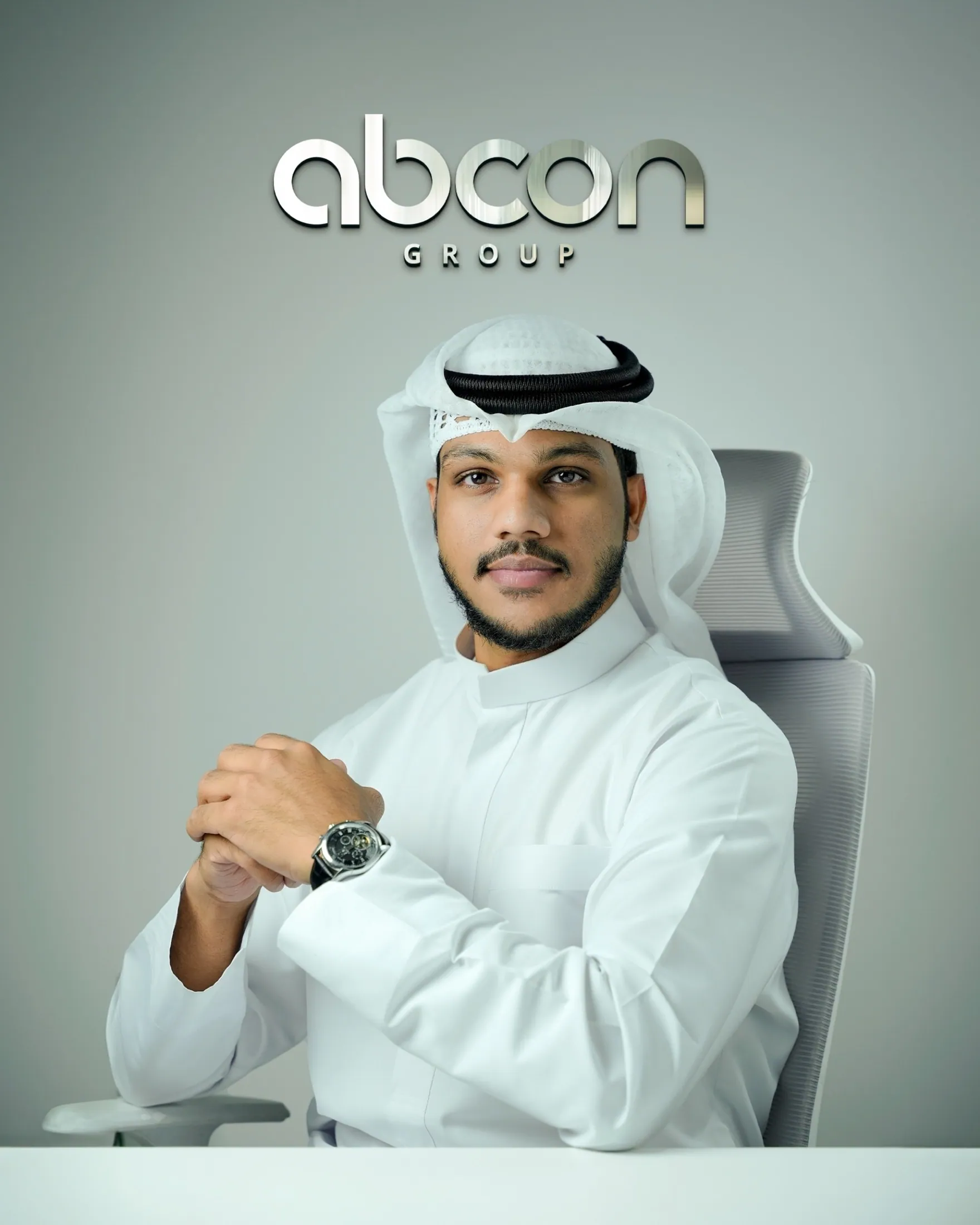 Muhammed Shafad seated in a white kandura in front of the Abcon Group backdrop